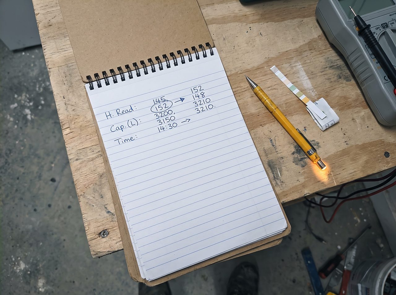 handwritten notes recording softener hardness and capacity settings before reprogramming