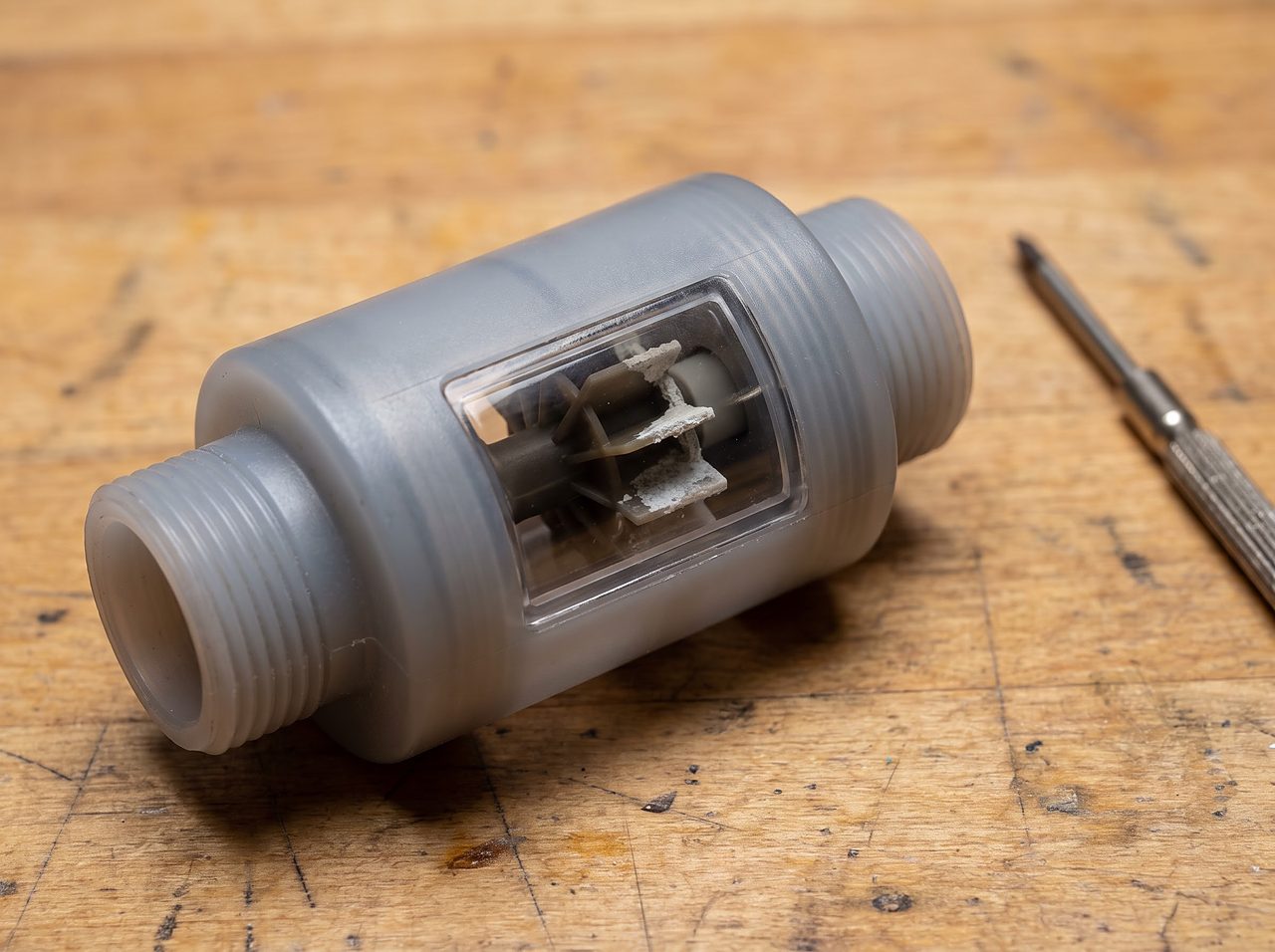 water meter turbine sensor with mineral scale removed from a softener valve for inspection