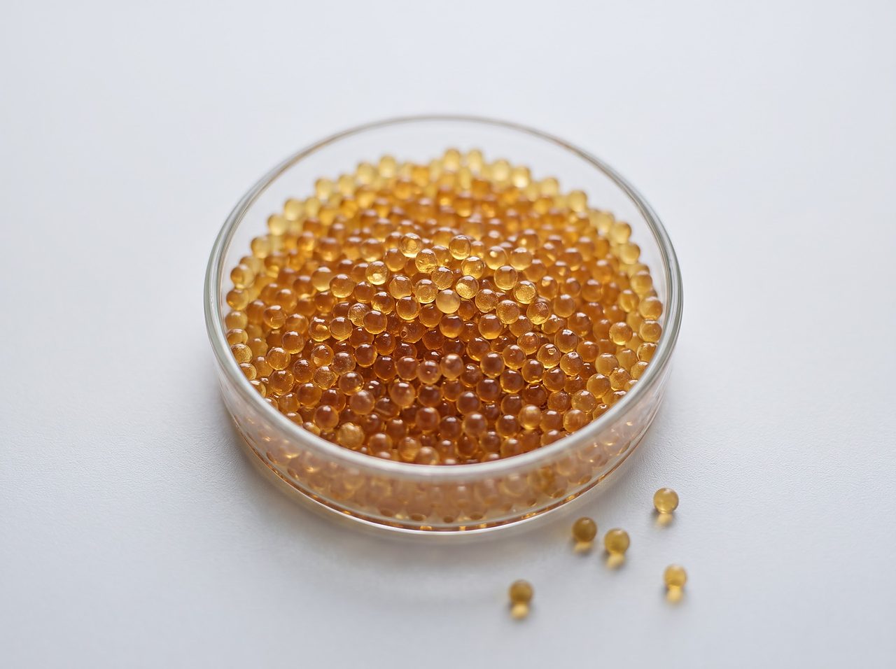 amber ion exchange resin beads in a glass dish