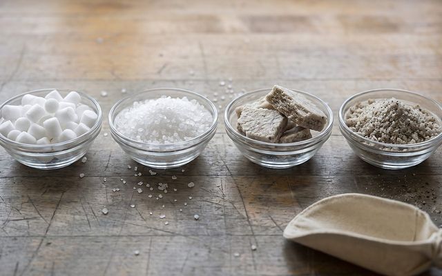 four bowls comparing pellet, crystal, compressed, and mined water softener salt textures